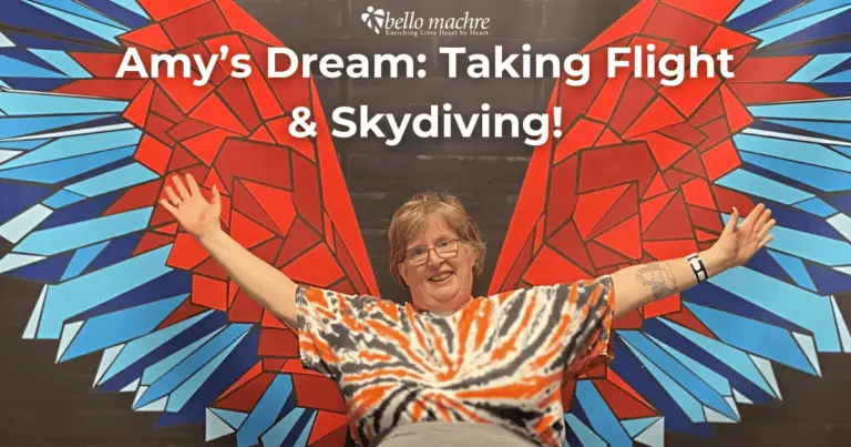 Bello Machre resident, Amy, posing in front of wings mural