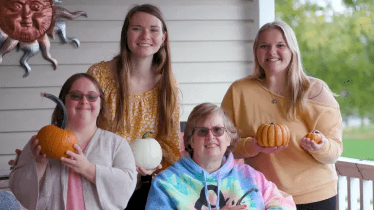 DSPs and Bello Residents posing on porch with pumpkins