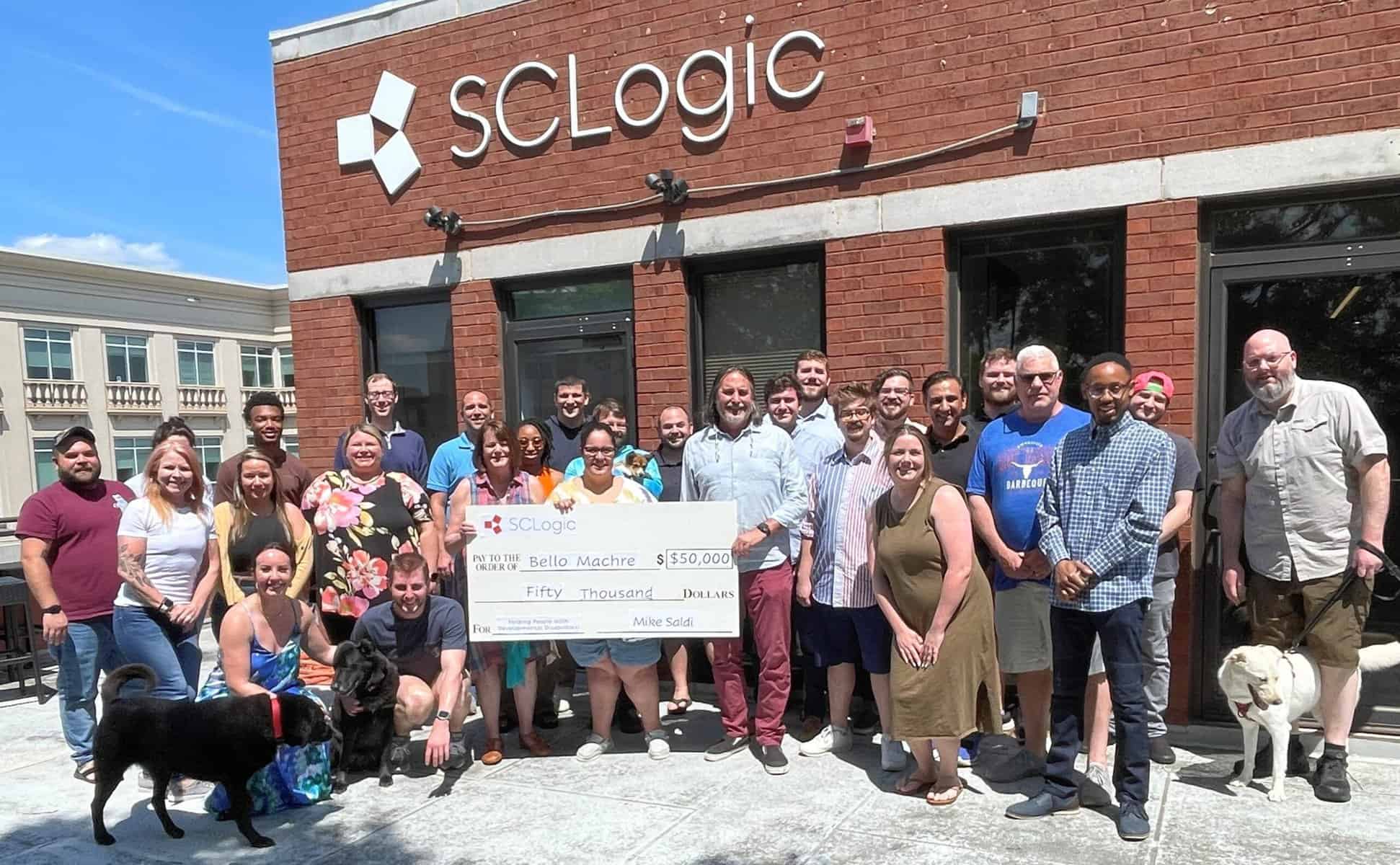 Group from SC Logic presenting donation check to Bello Machre