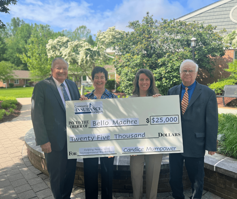 Commercial Insurance Managers reps presenting charity donation to Dr. Ireland