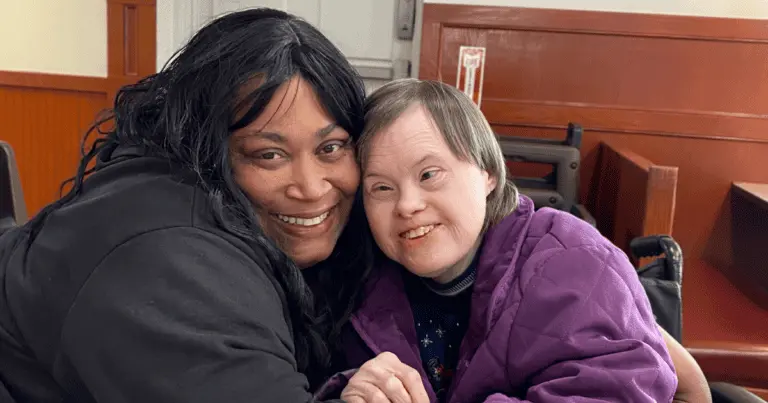 DSP and Bello Machre participant heads together smiling at camera