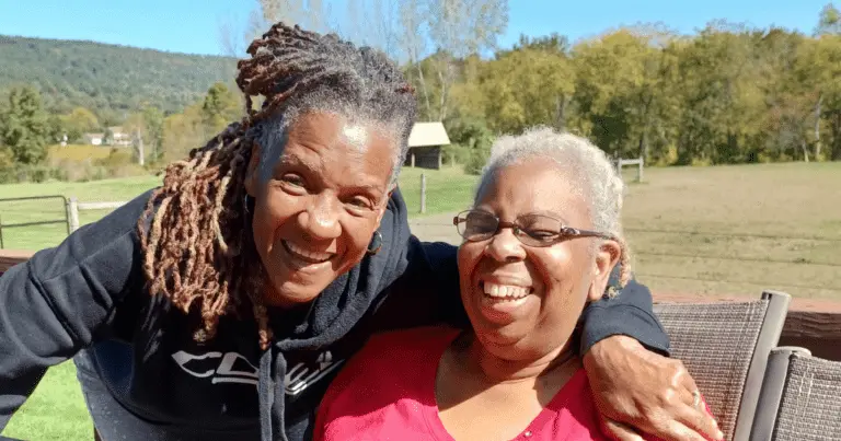 Bello Machre DSP and Resident in a park, smiling